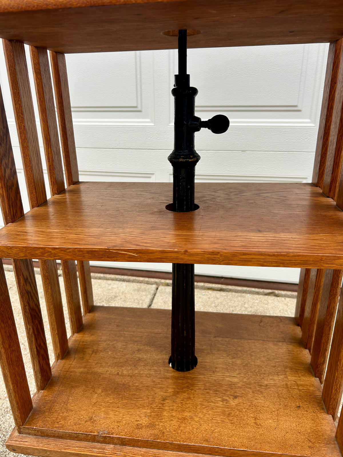 ANTIQUE OAK REVOLVING STANDING BOOKCASE MANFACTURED BY ON ORNATE CAST IRON BASE