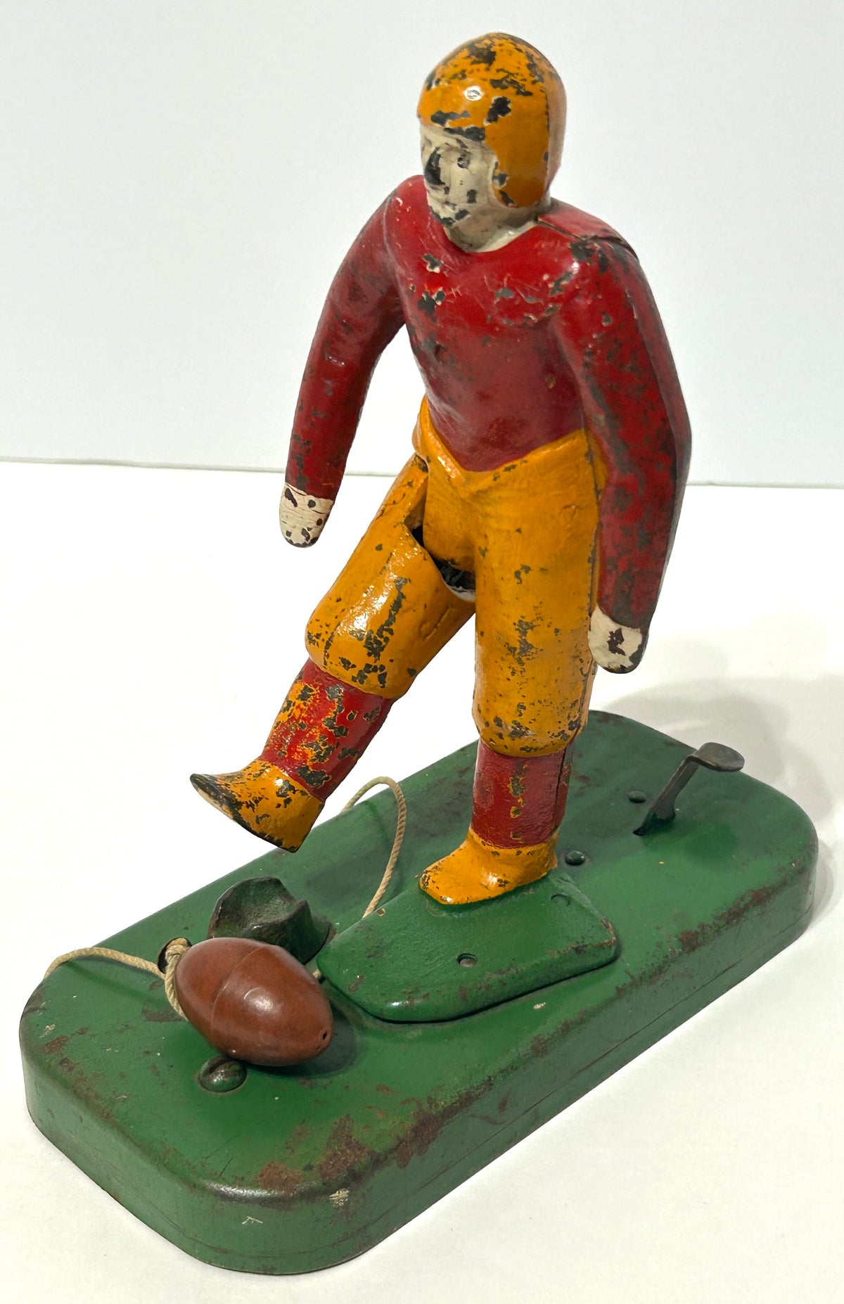 WOOLSEY MECHANICAL FOOTBALL PLAYER KICKING FOOTBALL  IN CAST IRON AND METAL