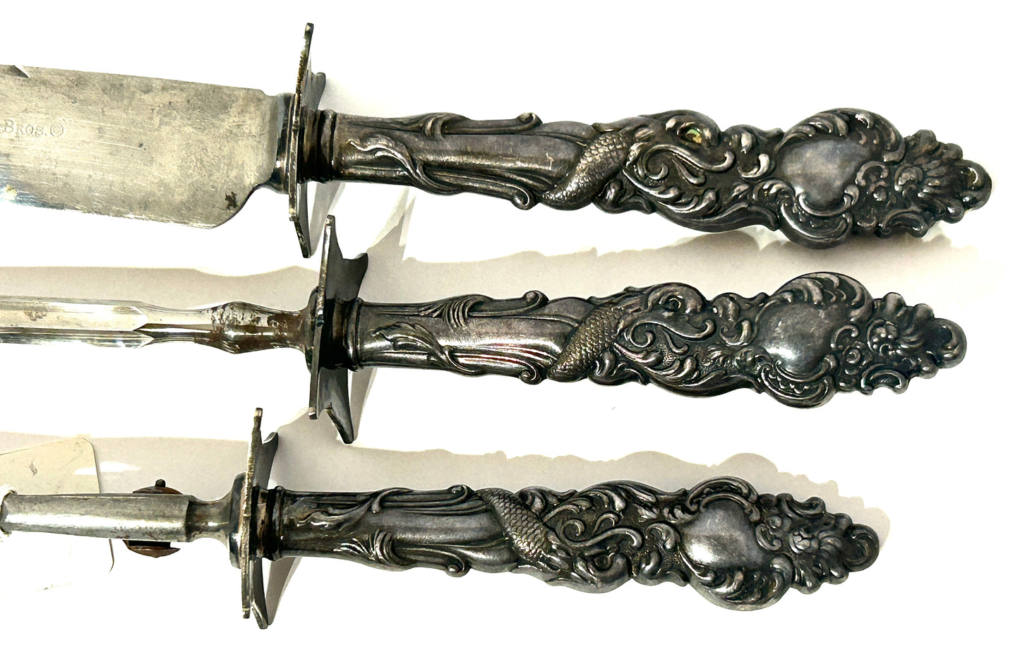 ANTIQUE 3 PIECE CARVING SET WITH SILVER PLATE HANDLES WITH SEA SERPENTS