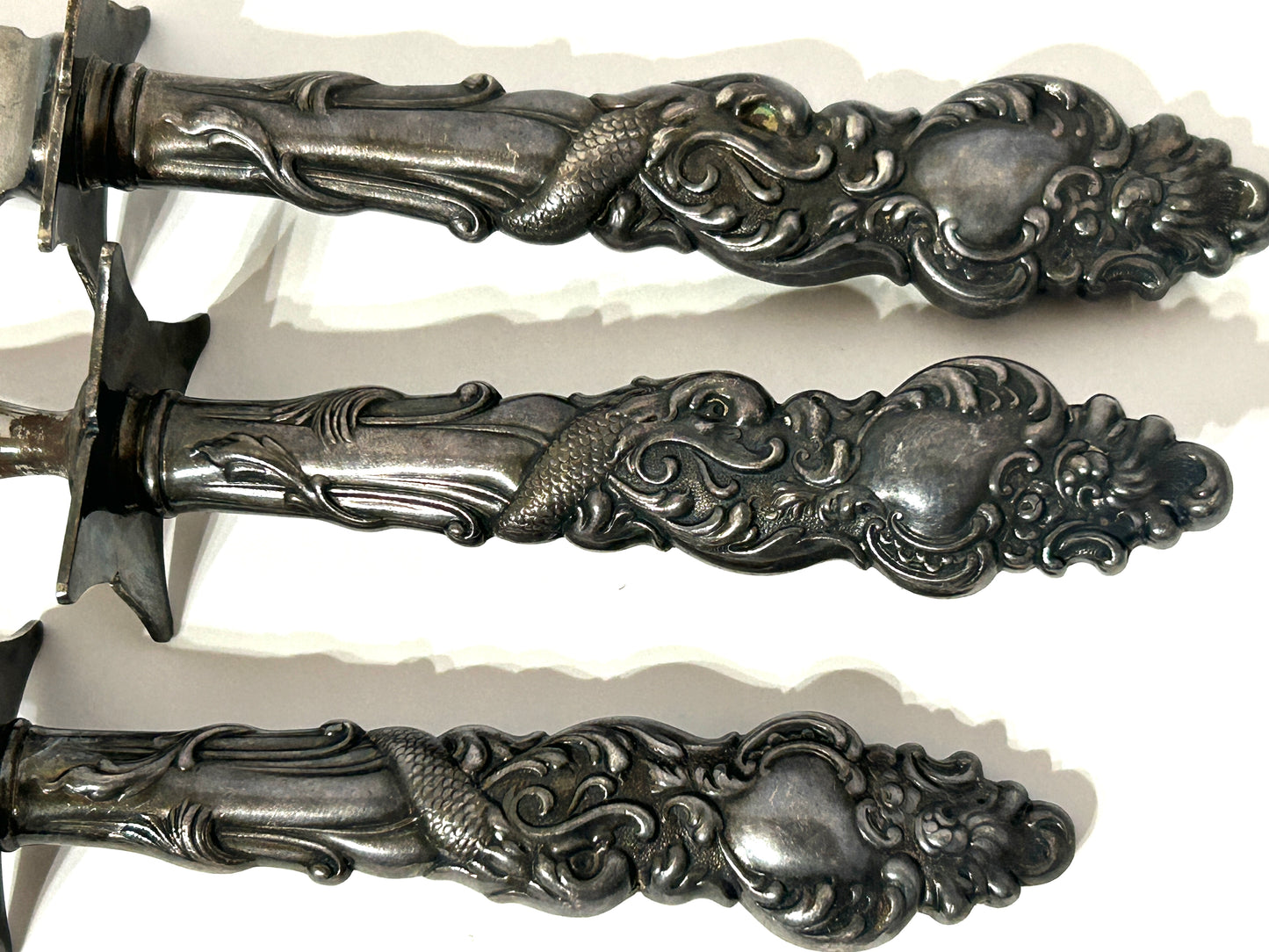 ANTIQUE 3 PIECE CARVING SET WITH SILVER PLATE HANDLES WITH SEA SERPENTS