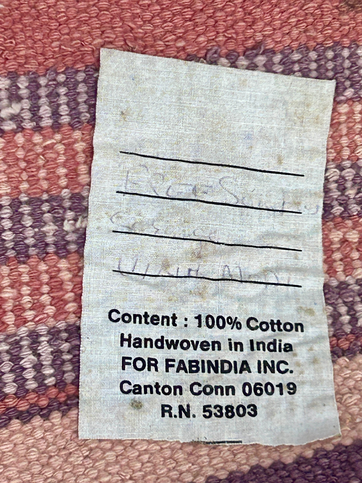 HANDMADE INDIA MAUVE AND PURPLE TRIBAL RUG MARKED WITH FABINDIA LABEL OR REVERSE