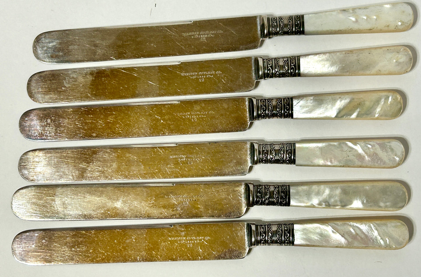 ANTIQUE STERLING AND MOTHER OF PEARL HANDLED SET OF KNIVES